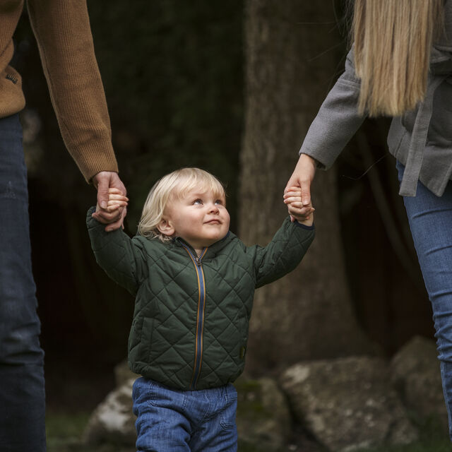 Parents walking with cute kid park 1