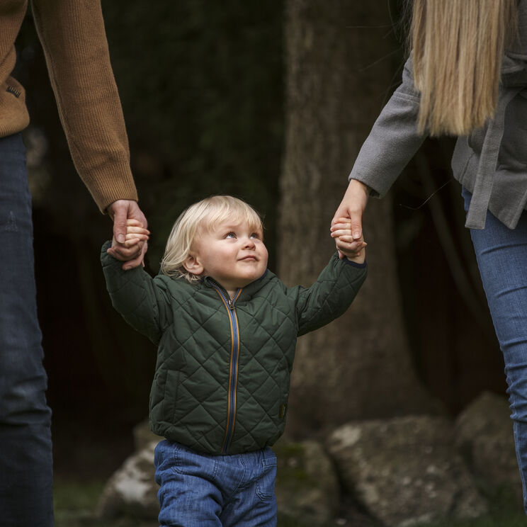 Parents walking with cute kid park 1