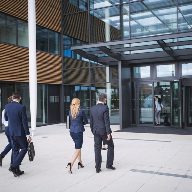 Business people entering office building 1