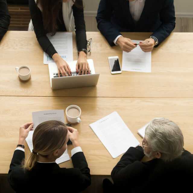 Diverse business colleagues working together meeting vertical top view
