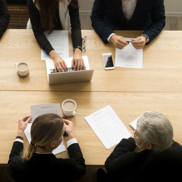 Diverse business colleagues working together meeting vertical top view